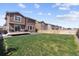 Fenced backyard with well-kept lawn and a deck, perfect for outdoor enjoyment at 13221 E 110Th Pl, Commerce City, CO 80022