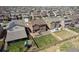 Aerial view of a fenced backyard with a green lawn, deck with outdoor seating, and beautiful landscaping at 13221 E 110Th Pl, Commerce City, CO 80022