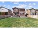 Spacious backyard with a well-maintained lawn, deck, and fenced perimeter at 13221 E 110Th Pl, Commerce City, CO 80022