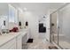 Bathroom featuring glass enclosed shower, double vanity, marble floors and bedroom access at 13221 E 110Th Pl, Commerce City, CO 80022