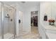 Bathroom featuring glass enclosed shower and doorway leading to closet at 13221 E 110Th Pl, Commerce City, CO 80022