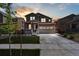 Inviting two-story home featuring a well-manicured lawn and a spacious two-car garage at sunset at 13221 E 110Th Pl, Commerce City, CO 80022