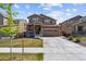 Beautiful two-story home with a well-maintained lawn and a convenient two-car garage under a blue sky at 13221 E 110Th Pl, Commerce City, CO 80022