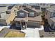 Inviting two-story home with solar panels, a covered porch, and a well-maintained front yard at 13221 E 110Th Pl, Commerce City, CO 80022