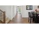Bright hallway with wood flooring, leading to a dining area and featuring a staircase to the upper level at 13221 E 110Th Pl, Commerce City, CO 80022