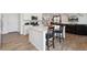 Modern kitchen with an island, stainless steel appliances, granite countertops, and hardwood floors at 13221 E 110Th Pl, Commerce City, CO 80022