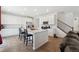 Bright kitchen boasts a large island with quartz countertops, stainless steel appliances, and white cabinetry at 13221 E 110Th Pl, Commerce City, CO 80022