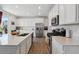 Bright kitchen featuring quartz countertops, stainless steel appliances, and ample cabinet space at 13221 E 110Th Pl, Commerce City, CO 80022