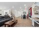 Open living area with wood flooring, a modern kitchen, a comfortable couch, and a dining area at 13221 E 110Th Pl, Commerce City, CO 80022