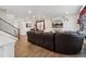 Open-concept living room featuring wood floors, recessed lighting, and a decorative 'Gathering' wall art piece at 13221 E 110Th Pl, Commerce City, CO 80022