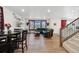 Spacious living area features wood floors, a comfortable seating arrangement, and staircase to upper level at 13221 E 110Th Pl, Commerce City, CO 80022