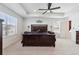 Spacious main bedroom with decorative tray ceiling, fan and large window at 13221 E 110Th Pl, Commerce City, CO 80022