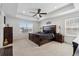 Elegant bedroom featuring a tray ceiling, large windows, and stylish dark wood furniture at 13221 E 110Th Pl, Commerce City, CO 80022