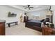 Bright and airy main bedroom with tray ceilings, dark wood furnishings and ensuite bathroom at 13221 E 110Th Pl, Commerce City, CO 80022