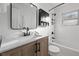 Updated bathroom with a marble vanity, black fixtures, and a shower/tub at 3061 S Grant St, Englewood, CO 80113