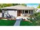 Gray craftsman home with a charming front porch and well-manicured lawn at 3061 S Grant St, Englewood, CO 80113