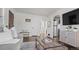 Open living room with hardwood floors, looking toward kitchen at 3061 S Grant St, Englewood, CO 80113