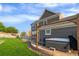 Hot tub on a concrete patio with wooden structure outside the gray two-story home at 9515 E 109Th Cir, Commerce City, CO 80640