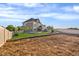 Expansive backyard with a gray two-story home, white fencing, and potential for landscaping at 9515 E 109Th Cir, Commerce City, CO 80640