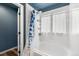 Bathroom with shower-tub combination, white tile and blue accent shower curtain at 9515 E 109Th Cir, Commerce City, CO 80640