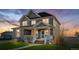Charming two-story home featuring a welcoming front porch, manicured lawn, and traditional design elements at 9515 E 109Th Cir, Commerce City, CO 80640