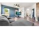 Comfortable living room with a modern ceiling fan, gray sectional couch, and wood-look flooring at 9515 E 109Th Cir, Commerce City, CO 80640