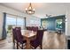 Bright and airy living room featuring an adjacent dining area, hardwood floors, and lots of natural light at 9515 E 109Th Cir, Commerce City, CO 80640