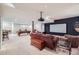 A finished basement featuring a projector screen, pool table, and ample seating area at 7452 S Utica St, Littleton, CO 80128