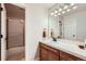 Bright bathroom with tile countertops, wooden vanity, and a separate shower and tub at 7452 S Utica St, Littleton, CO 80128