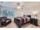 Comfortable bedroom with a ceiling fan, large windows, and a cozy sitting area at 7452 S Utica St, Littleton, CO 80128