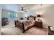Elegant bedroom showcasing a plush bed, a ceiling fan and bright, shuttered windows at 7452 S Utica St, Littleton, CO 80128