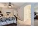Comfortable bedroom with a ceiling fan, soft carpet, and hall and bathroom access at 7452 S Utica St, Littleton, CO 80128