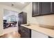 Bonus room with a sink and storage cabinets, open to a living area with ample lighting at 7452 S Utica St, Littleton, CO 80128