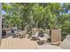 Deck area with table and chairs surrounded by trees at 7452 S Utica St, Littleton, CO 80128