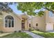 Inviting two-story home with a well-manicured lawn, arched window, and brick pathway at 7452 S Utica St, Littleton, CO 80128