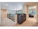 Well-lit hallway with storage and leading into a cozy sitting area with a comfortable armchair at 7452 S Utica St, Littleton, CO 80128