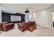 Home theater setup with a projector screen, comfortable seating, and recessed lighting at 7452 S Utica St, Littleton, CO 80128