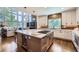 Open kitchen with a large island, wine fridge, and modern finishes, and sight lines to the living room at 7452 S Utica St, Littleton, CO 80128