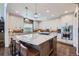 Spacious kitchen featuring a large central island with barstool seating and modern appliances at 7452 S Utica St, Littleton, CO 80128