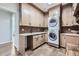 Well-organized laundry room with plenty of cabinet space and a stacked washer and dryer at 7452 S Utica St, Littleton, CO 80128