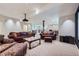 Living room with a projector, comfortable seating, recessed lights, and access to game room at 7452 S Utica St, Littleton, CO 80128