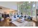 Open-concept living room with hardwood floors, natural light, and stylish sectional sofa at 7452 S Utica St, Littleton, CO 80128