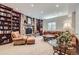 Living room featuring a stone fireplace, built-in bookshelves, and comfortable seating at 7452 S Utica St, Littleton, CO 80128