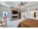 Stylish main bedroom with a modern fireplace, TV, and convenient access to the outside at 7452 S Utica St, Littleton, CO 80128