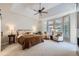 Spacious main bedroom featuring a tray ceiling, large windows, and comfortable seating area at 7452 S Utica St, Littleton, CO 80128
