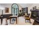 Cozy home office with a large arched window, built-in bookshelves, and fireplace at 7452 S Utica St, Littleton, CO 80128