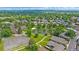 A picturesque aerial view highlights a pond with fountain, mature landscaping, and surrounding neighborhood at 31 Irene Ct, Broomfield, CO 80020