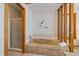 A bathtub shower combination featuring a tiled tub with shower head and a small window for natural light at 31 Irene Ct, Broomfield, CO 80020