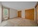 A bright bedroom with carpet and two large wooden closets near a window with natural light streaming in at 31 Irene Ct, Broomfield, CO 80020
