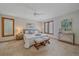 A bright bedroom with many windows, carpet, a king size bed, matching benches, and modern decorations at 31 Irene Ct, Broomfield, CO 80020